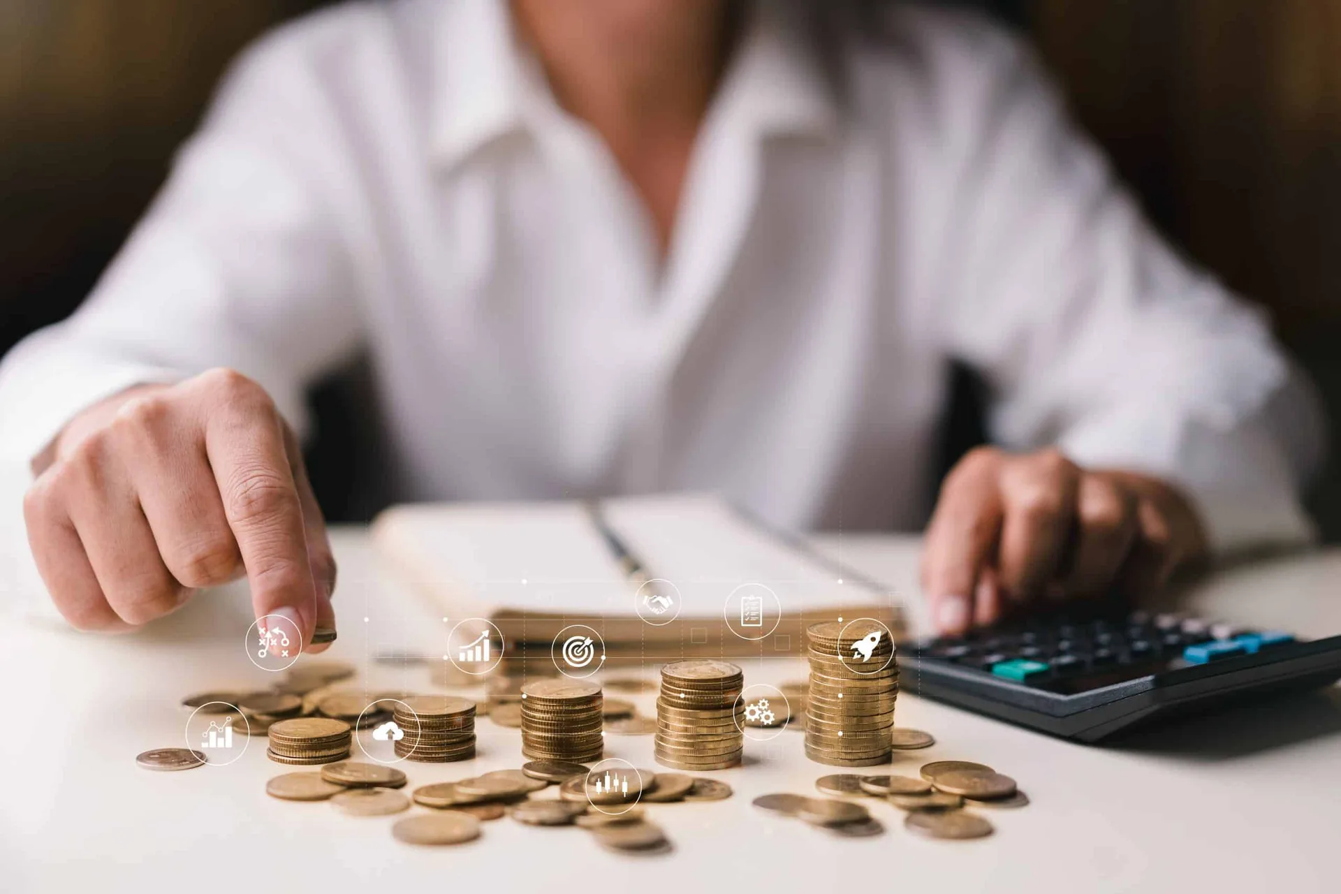 Businessman,Holding,Coins,Putting,On,Stacking,Coins,And,Using,Calculator